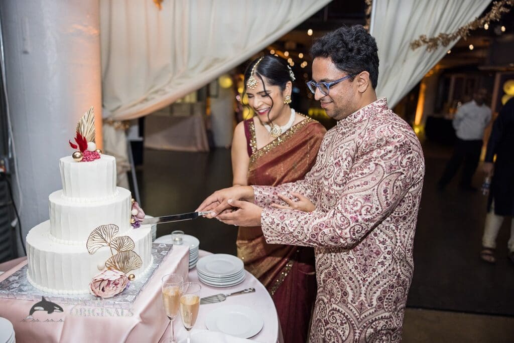 Happy couple cut the cake at the Torpedo Factory Art Center Wedding