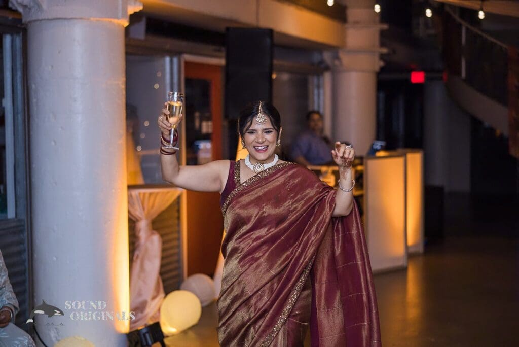 The bride with a glass of wine at her Torpedo Factory Art Center Wedding