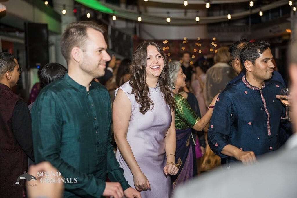 Guests smiling on the dance floor at the Torpedo Factory Art Center Wedding