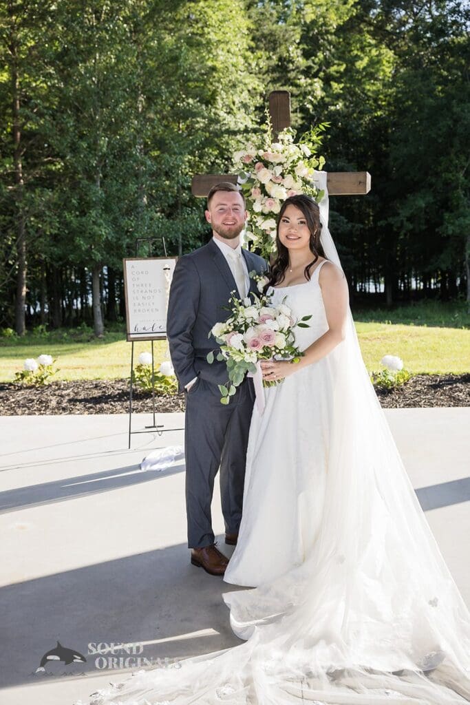 A portrait of the bride and groom at the altar of The Oakley on the Lake Wedding