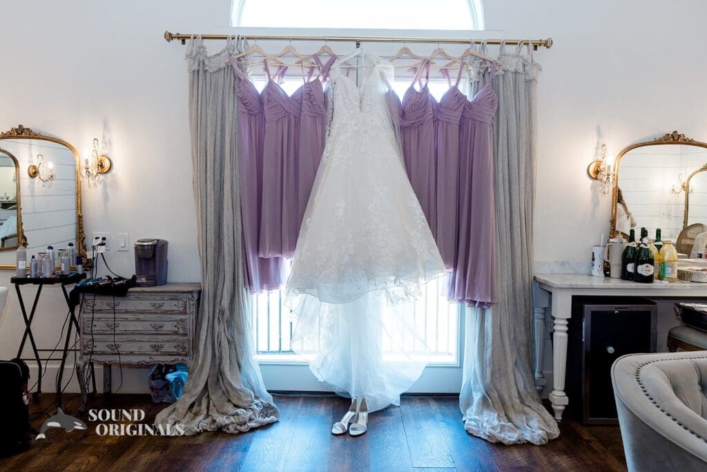 Sterling bride and bridal gowns hang pretty in The French Farmhouse Wedding room