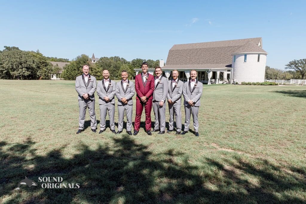 Photographer captures elegant groom with groom's men at The French Farmhouse outdoor