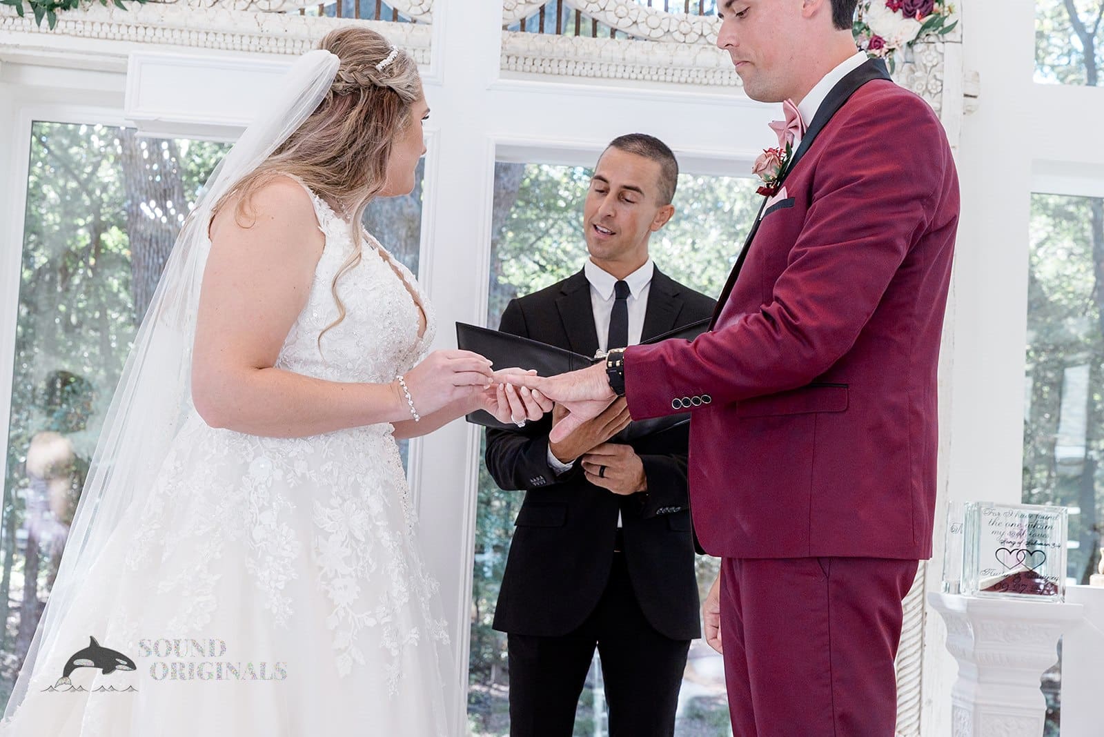 Bride and groom exchange marital vows and rings In The French Farmhouse Wedding altar