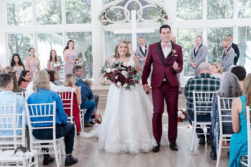 Husband and wife walking through the crowd in joy over a successful French Farmhouse Wedding