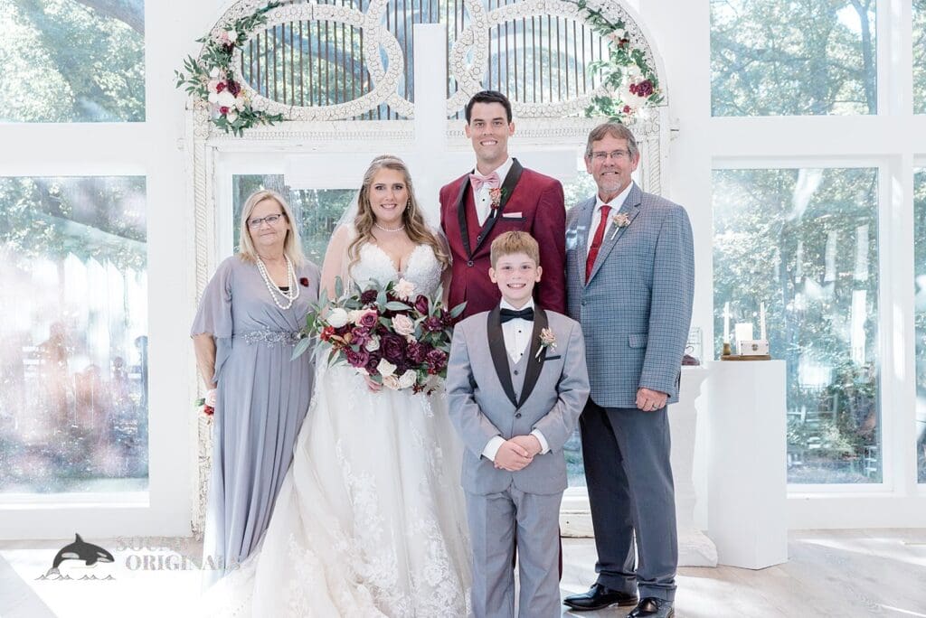Husband and wife take a charming shot with bride's parents and groom's boy after The French Farmhouse Wedding