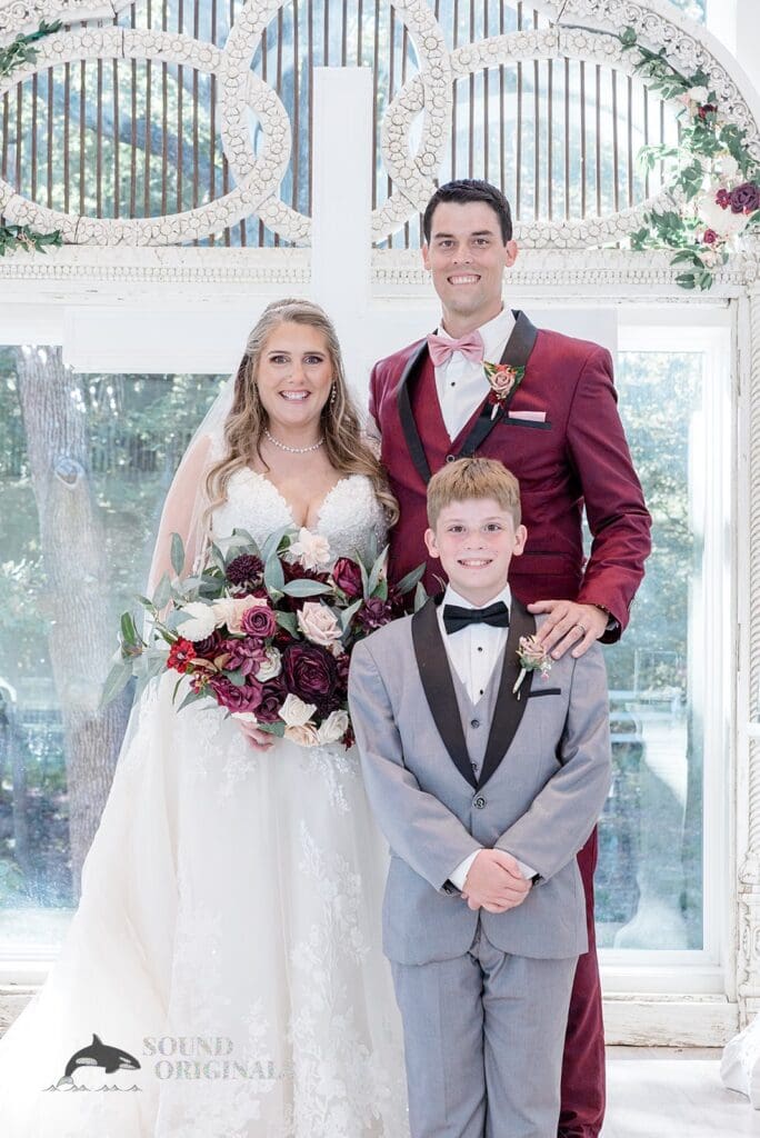 Husband and wife take a beautiful shot with groom's boy after The French Farmhouse Wedding