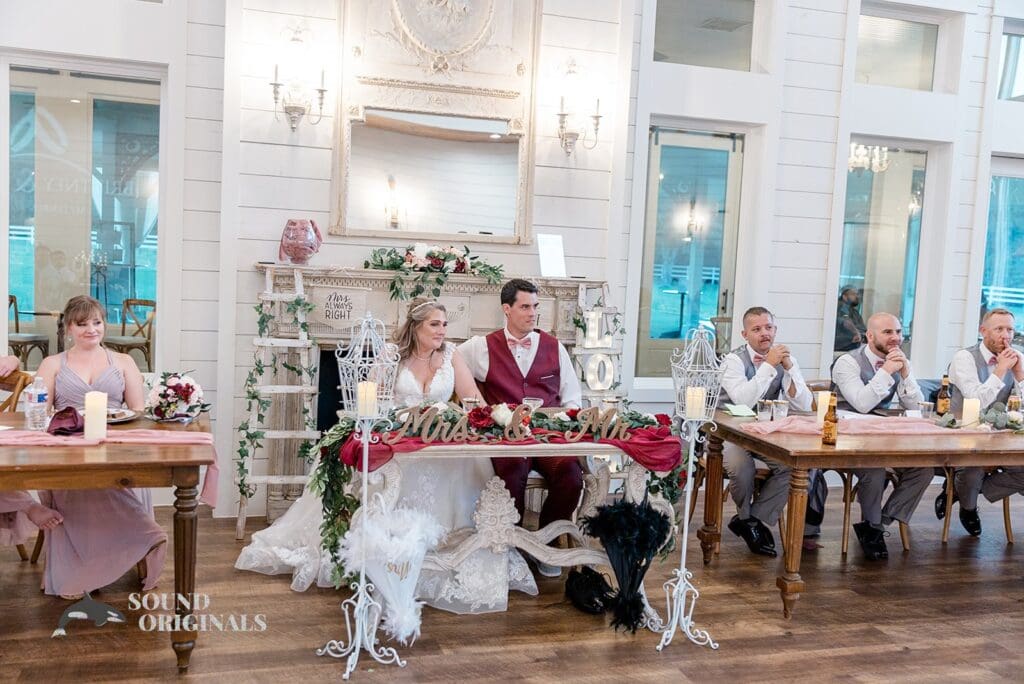 The French Farmhouse Wedding couple in the radiant couple seat with bridal train and groom's men beside