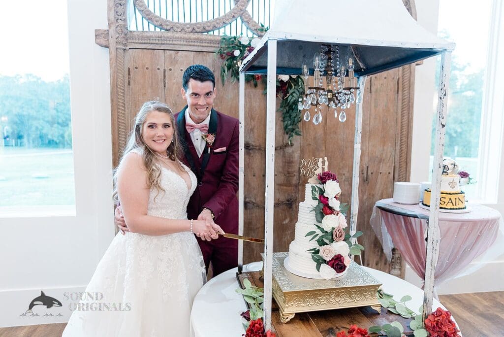 Husband and wife cut the cake in The French Farmhouse Wedding