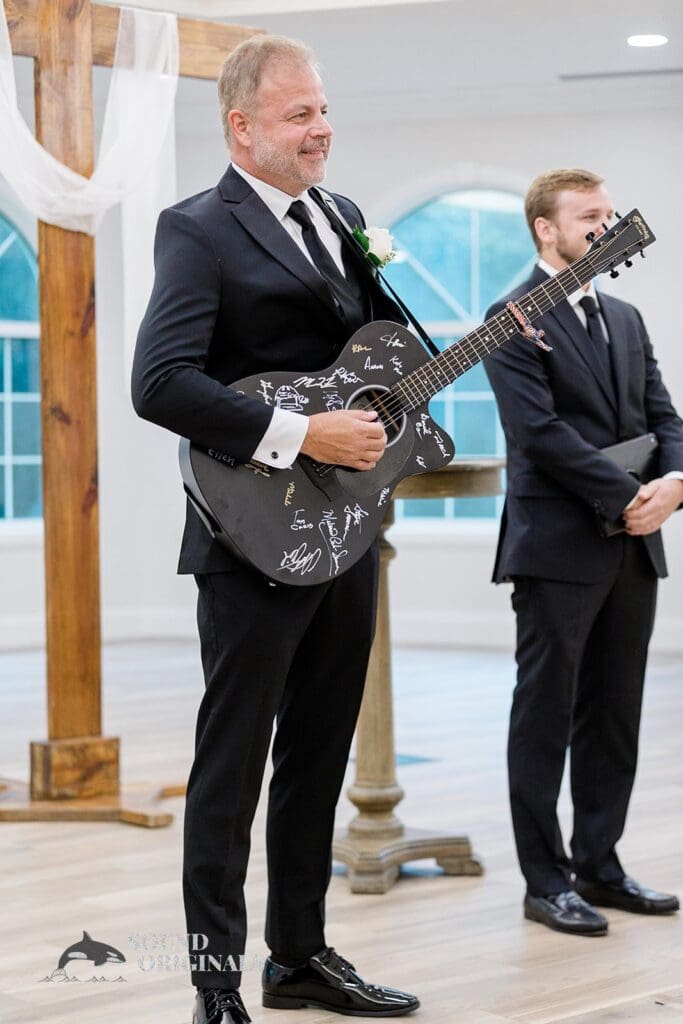 Harborside Chapel Wedding Groom with his guitar serenading during the Harborside Chapel Wedding