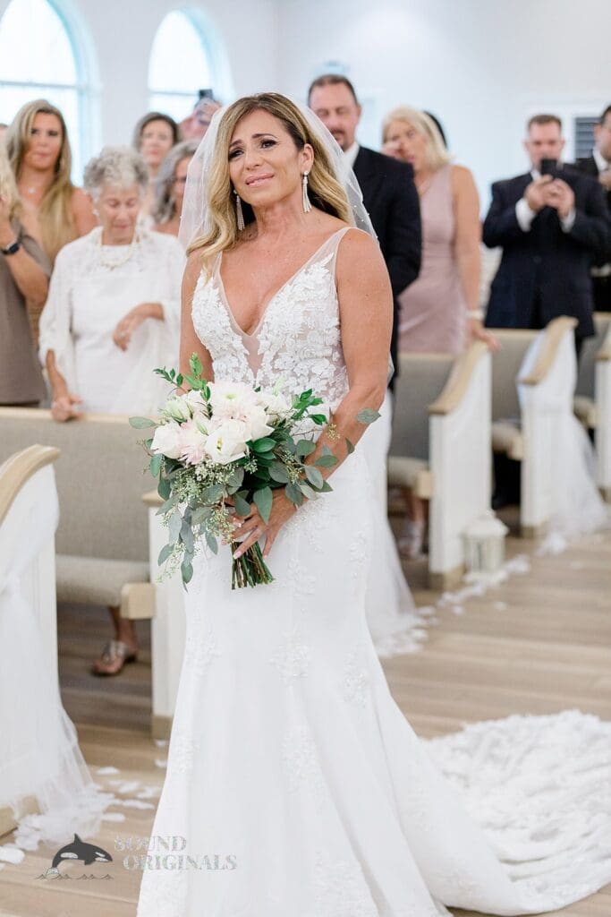 Harborside Chapel Wedding Bride with happy tears as she walks down the aisle during the Harborside Chapel Wedding