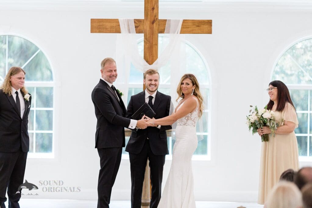 Harborside Chapel Wedding BRide and Groom hold hands at the altar during the Harborside Chapel Wedding