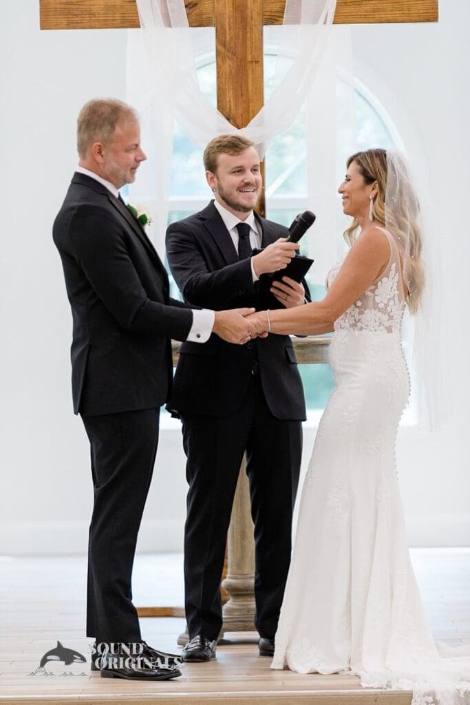 Harborside Chapel Wedding Bride and groom hold hands and gaze at each other during the Harborside Chapel Wedding