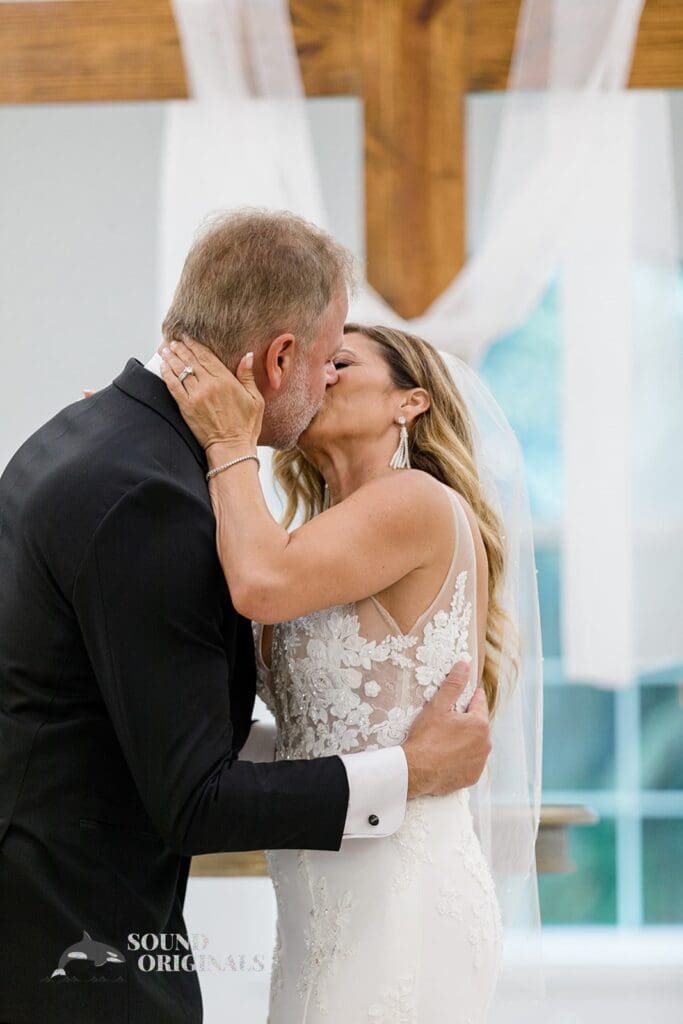 Harborside Chapel Wedding the newlyweds first kiss during the Harborside Chapel Wedding