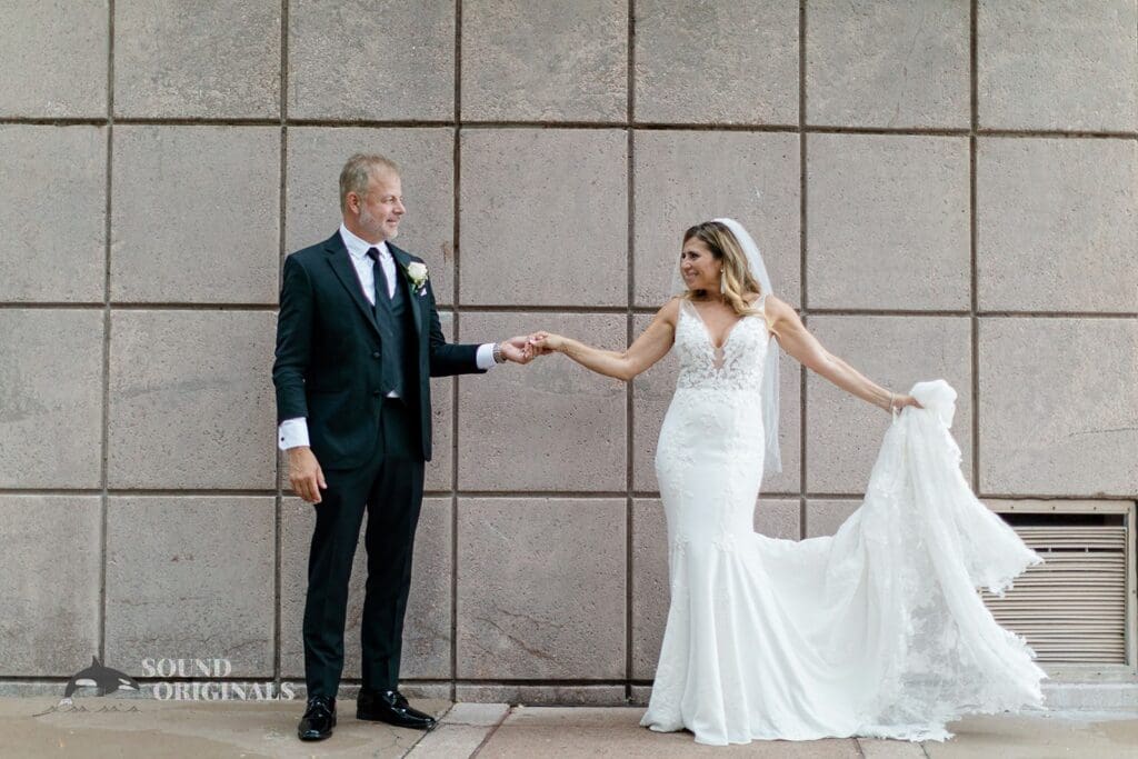 Harborside Chapel Wedding Newlyweds hold hands and pose after the Harborside Chapel Wedding