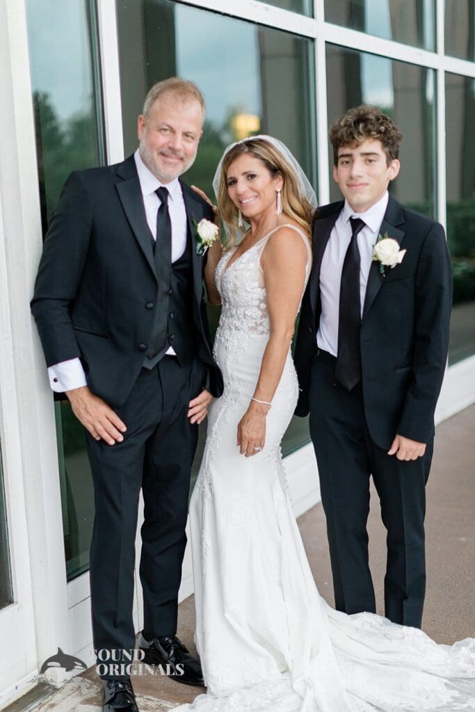 Harborside Chapel Wedding Newlyweds pose with their significant family member after the Harborside Chapel Wedding
