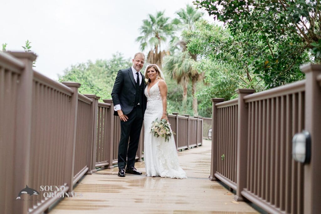 Harborside Chapel Wedding Newlyweds pose at the bridge of the hotel after the Harborside Chapel Wedding