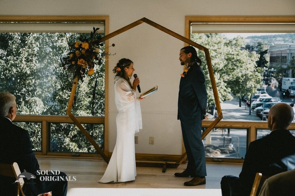 Moment bride reads out her marital vows to groom at the Rembrandt Yard altar