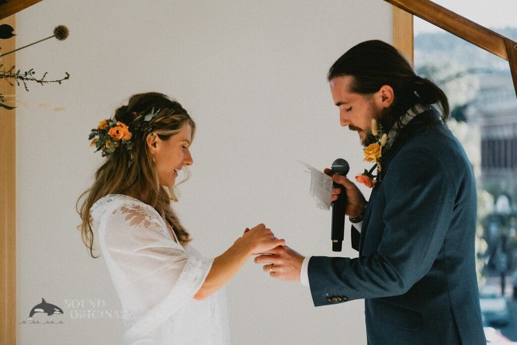 Bride and groom exchange rings in a Rembrandt Yard Wedding