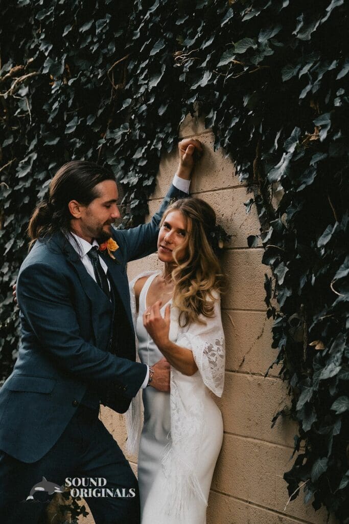 Romantic shot of husband and wife in front of wedding venue