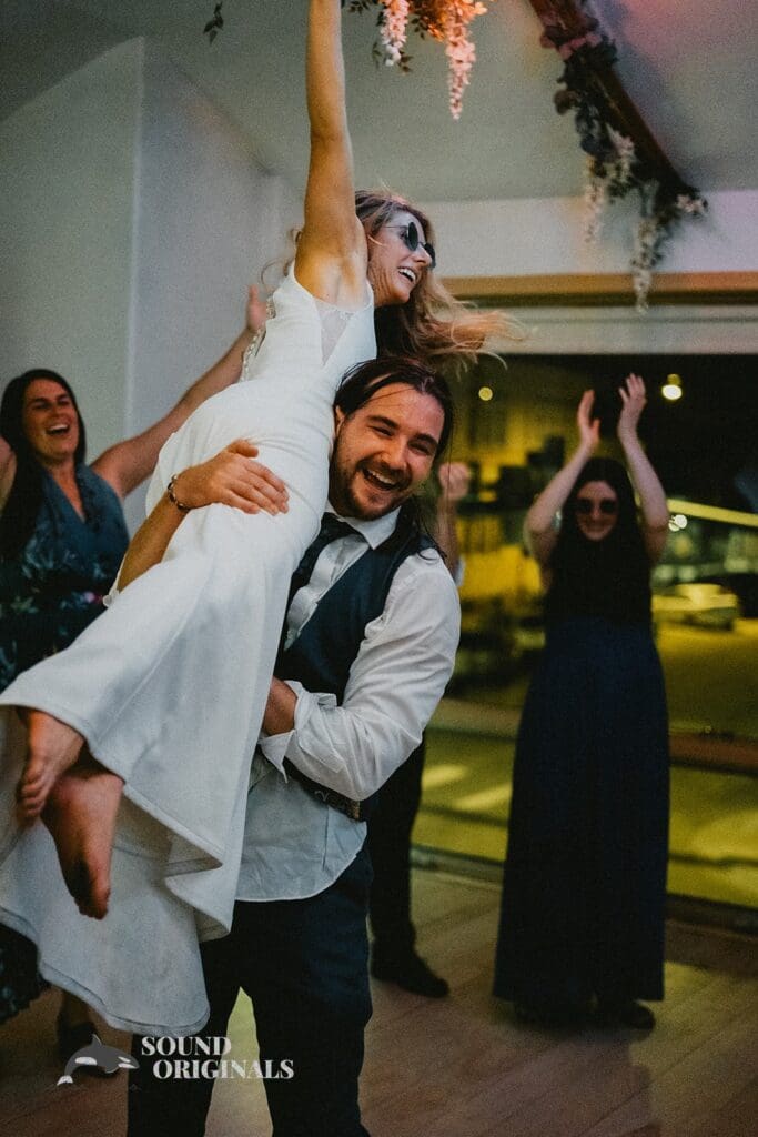 Moment happy groom lifts wife up in a Rembrandt Yard Wedding