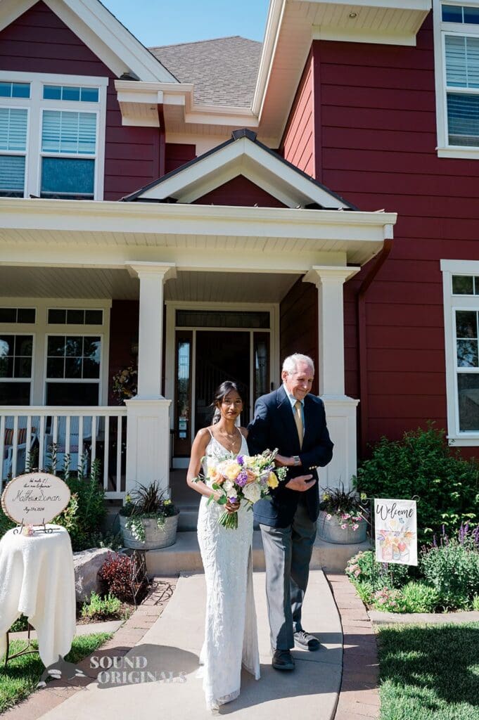 The bride walking with her dad at The Red Farmhouse Bed & Breakfast Wedding