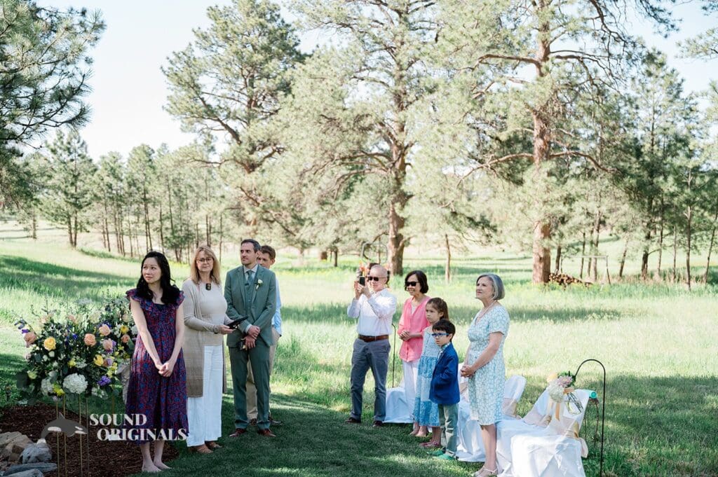 The guests watching the arrival of the bride at The Red Farmhouse Bed & Breakfast Wedding