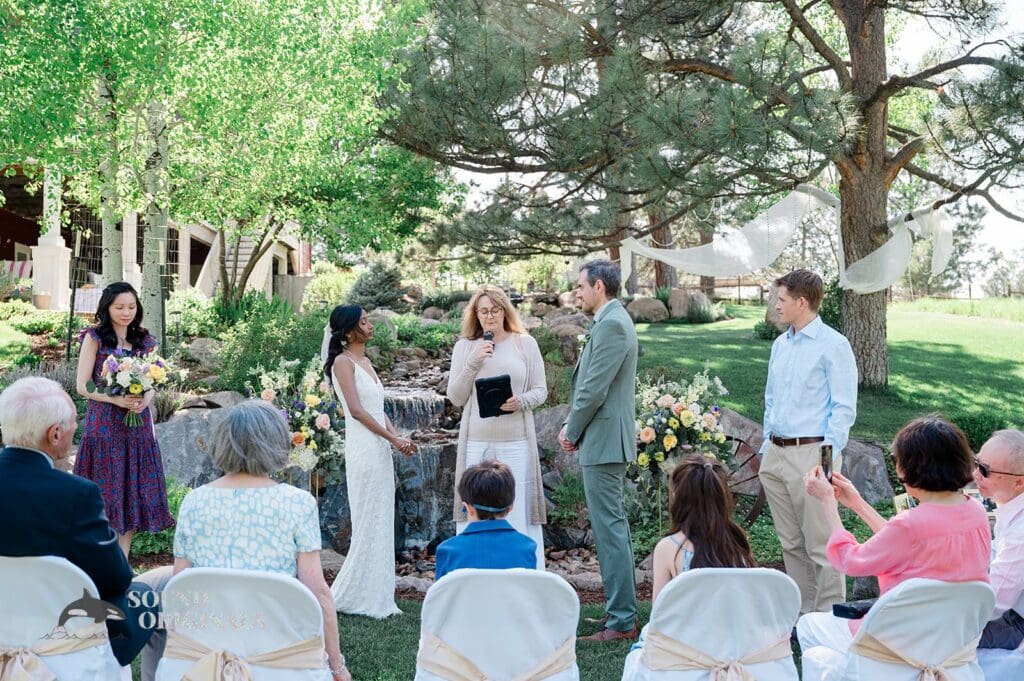 The bride and groom at the altar of The Red Farmhouse Bed & Breakfast Wedding