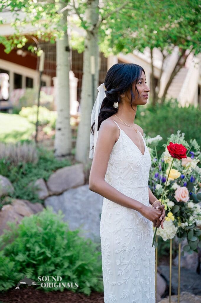 The bride standing at the altar with a rose for The Red Farmhouse Bed & Breakfast Wedding