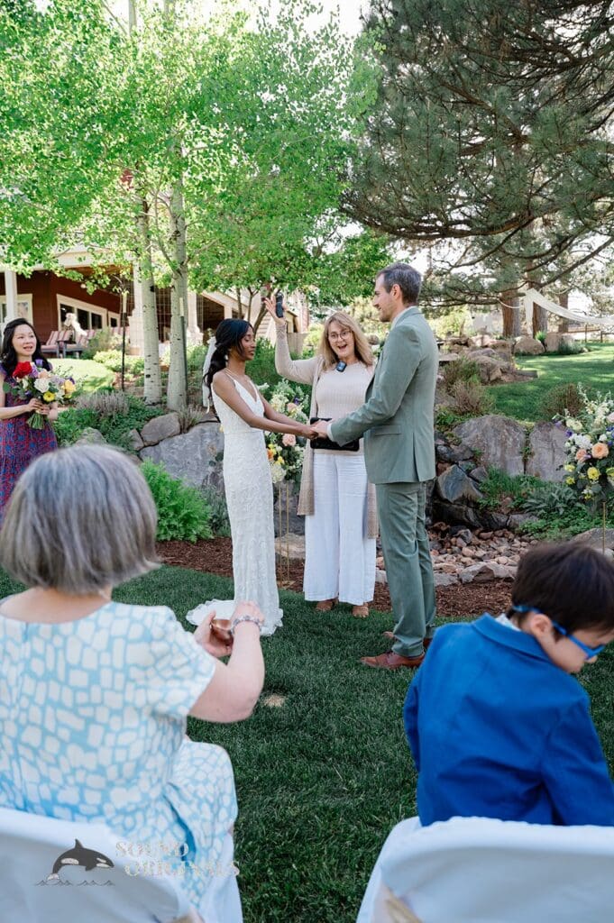 The bride and groom are married at The Red Farmhouse Bed & Breakfast Wedding