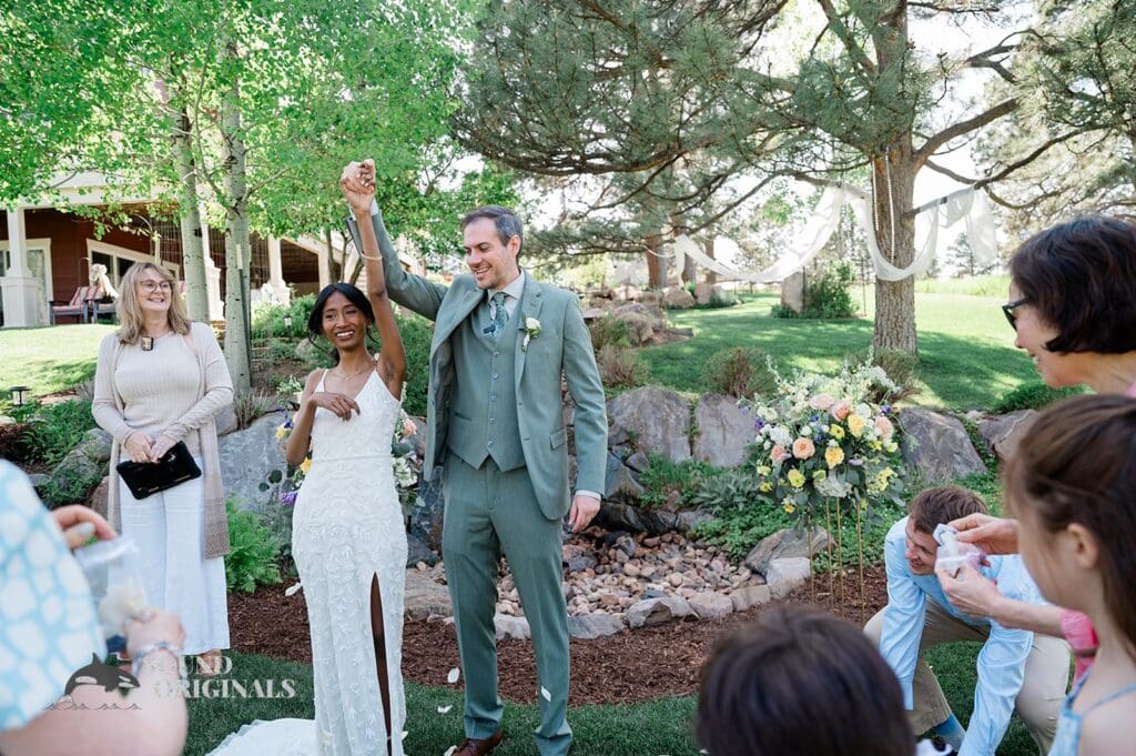 Bride and groom celebrate saying I do at The Red Farmhouse Bed & Breakfast Wedding