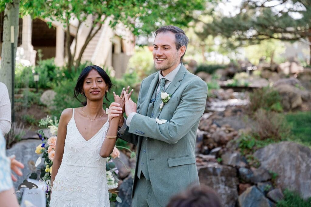 Bride and groom showing their wedding rings at The Red Farmhouse Bed & Breakfast Wedding