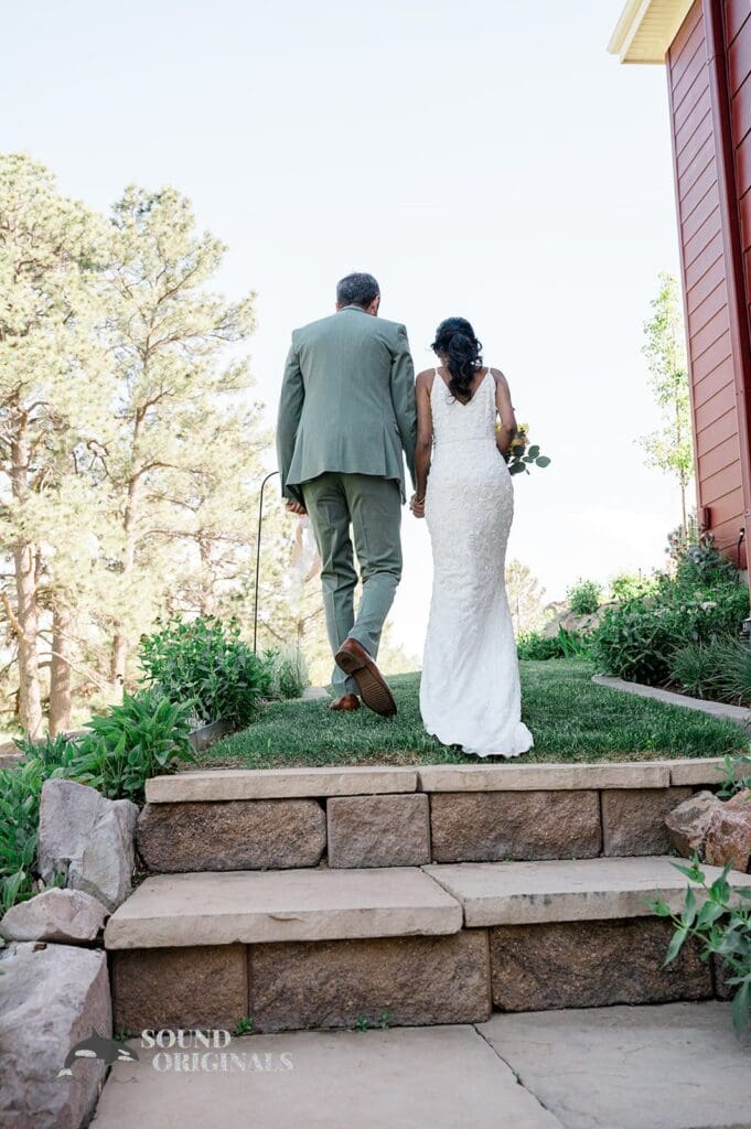 The bride and groom walking away at The Red Farmhouse Bed & Breakfast Wedding