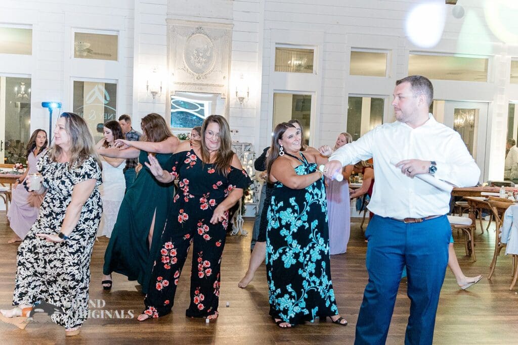 Happy guests dance to live music at The French Farmhouse Wedding