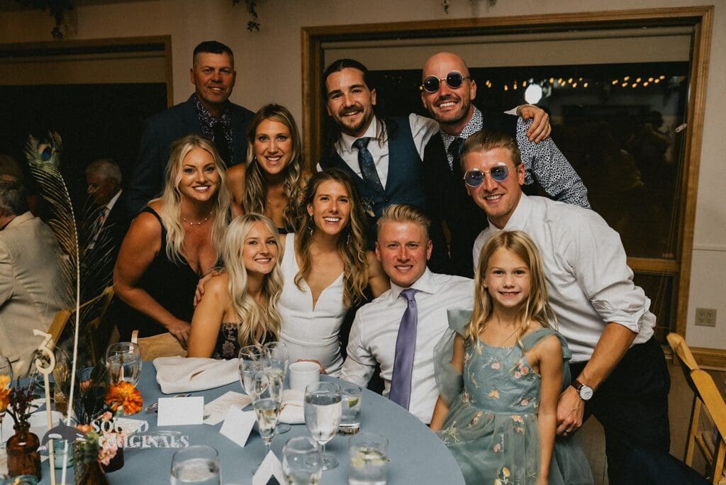 Bride takes a beautiful shot with groom's family in a Rembrandt Yard Wedding