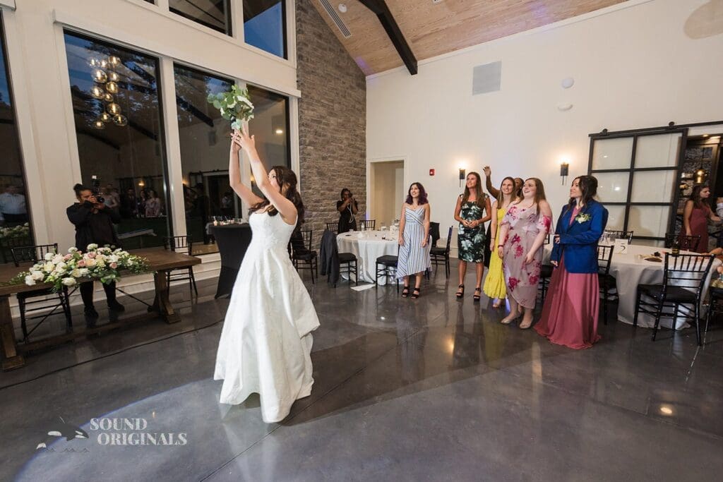 The bride throws her bouquet at The Oakley on the Lake Wedding