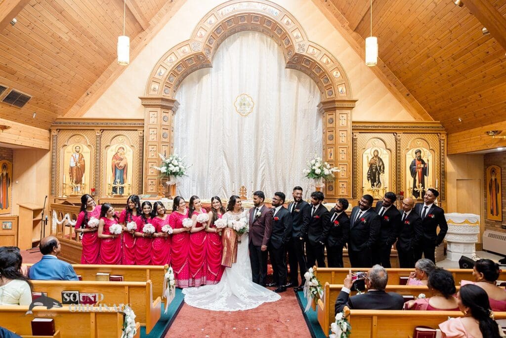 The bride, groom and bridal party at the altar at their Embassy Suites by Hilton Naperville Wedding