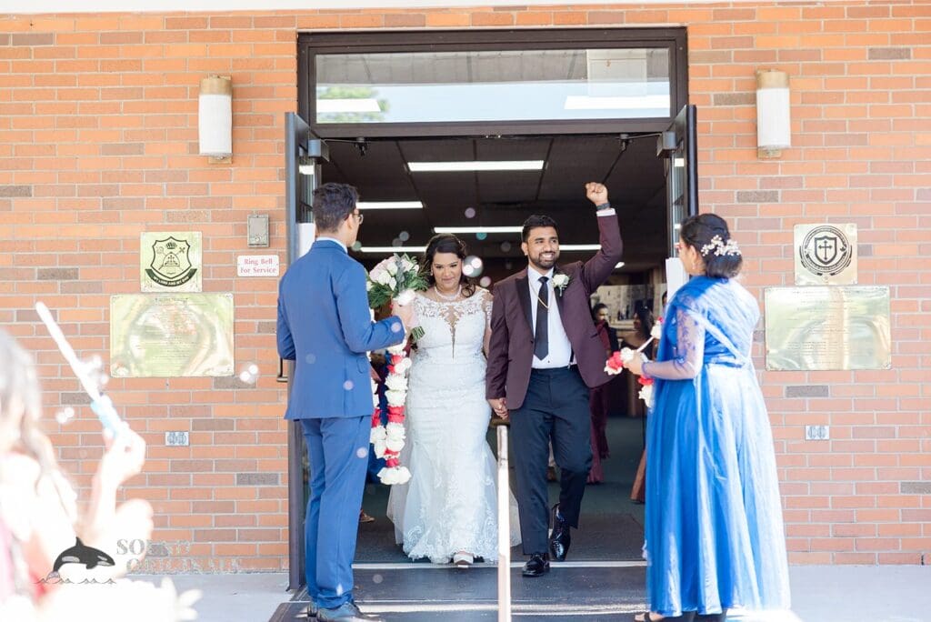 The bride and groom exiting their ceremony at their Embassy Suites by Hilton Naperville Wedding