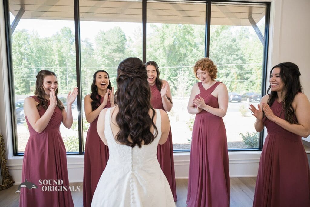 The bridesmaids seeing the bride for the first time at The Oakley on the Lake Wedding