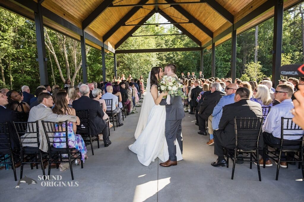 A kiss while leaving The Oakley on the Lake Wedding ceremony