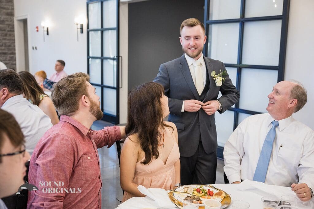 The groom mingling at The Oakley on the Lake Wedding