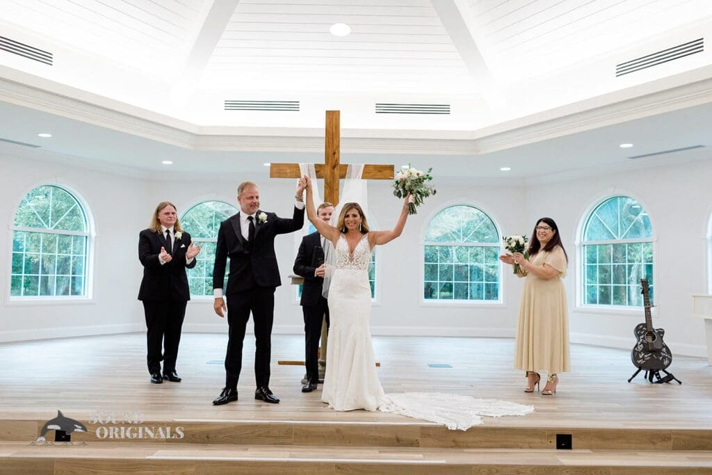 Harborside Chapel Wedding The newlyweds raise their hands for a scuccessful Harborside Chapel Wedding
