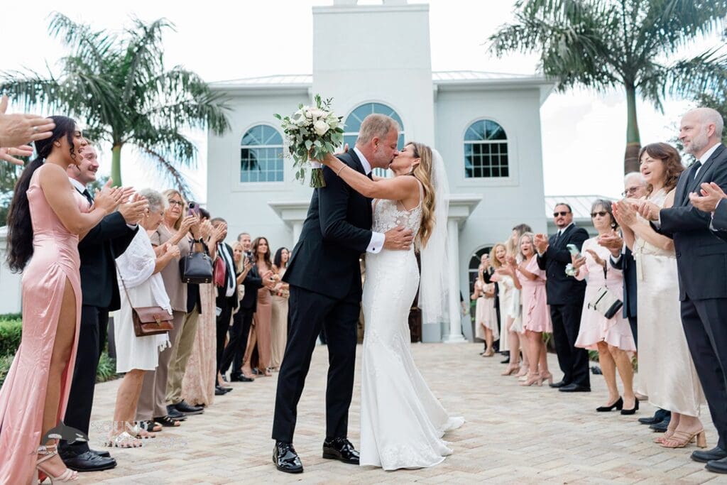 Harborside Chapel Wedding Newlyweds exit the Harborside Chapel Wedding and kiss in front of the cheering crowd