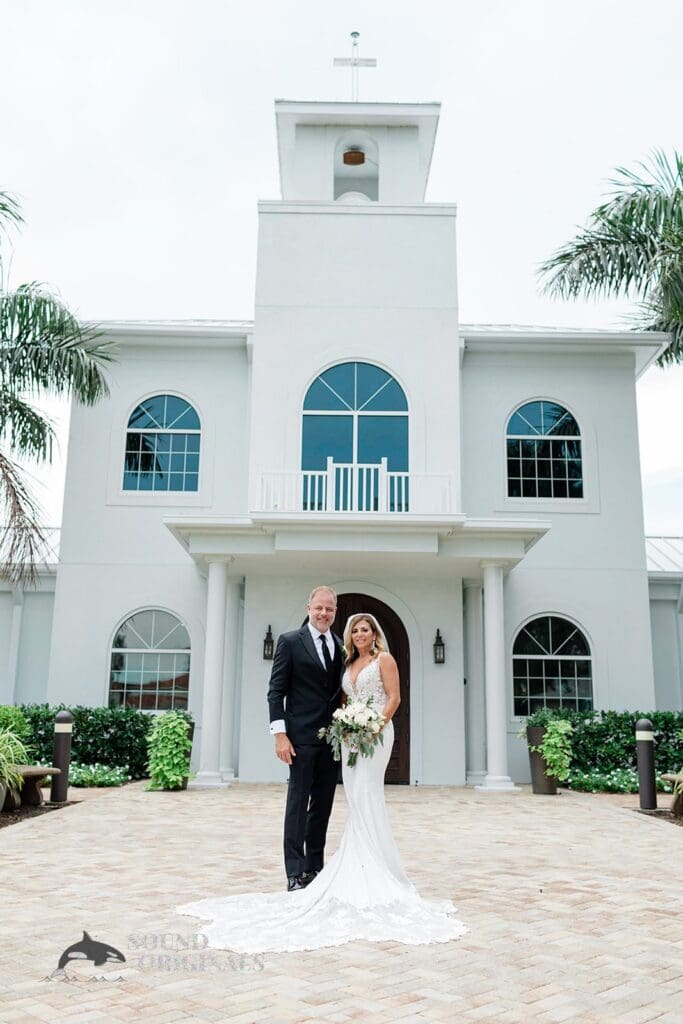 Harborside Chapel Wedding Newlyweds pose at the entrance of the Harborside Chapel Wedding