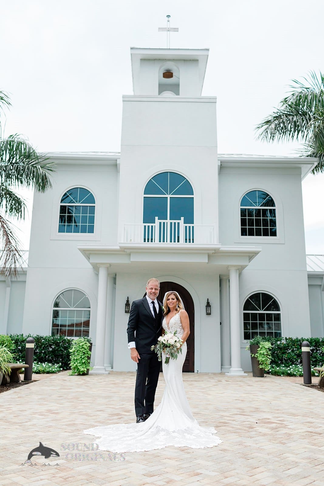 Newlyweds pose at the entrance of the Harborside Chapel Wedding