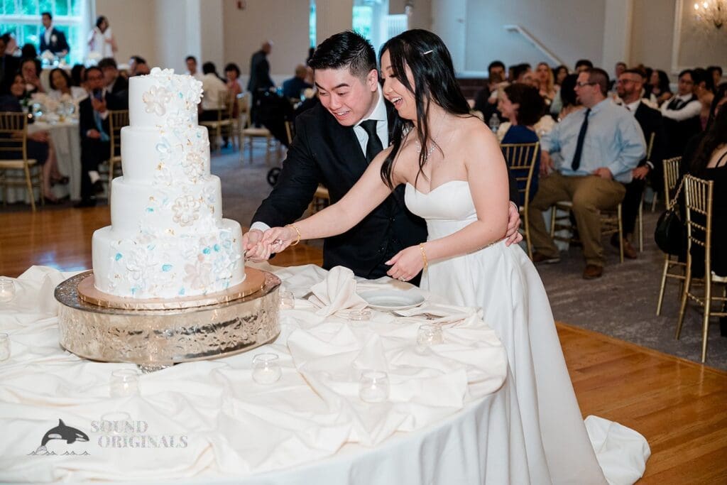 The couple cut the cake at The Abbington Distinctive Banquets Wedding