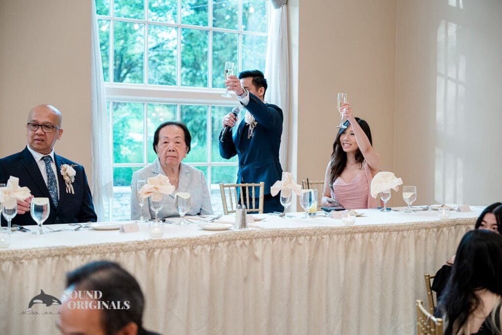 Guests raising a toast to the couple at The Abbington Distinctive Banquets Wedding