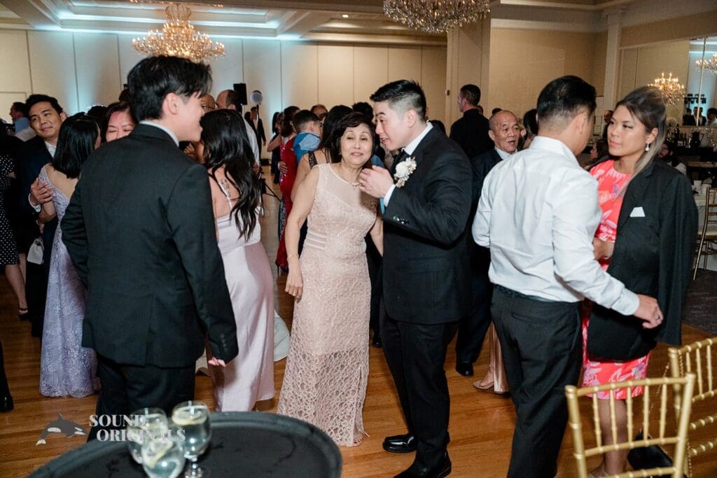 Groom talking to guests at The Abbington Distinctive Banquets Wedding