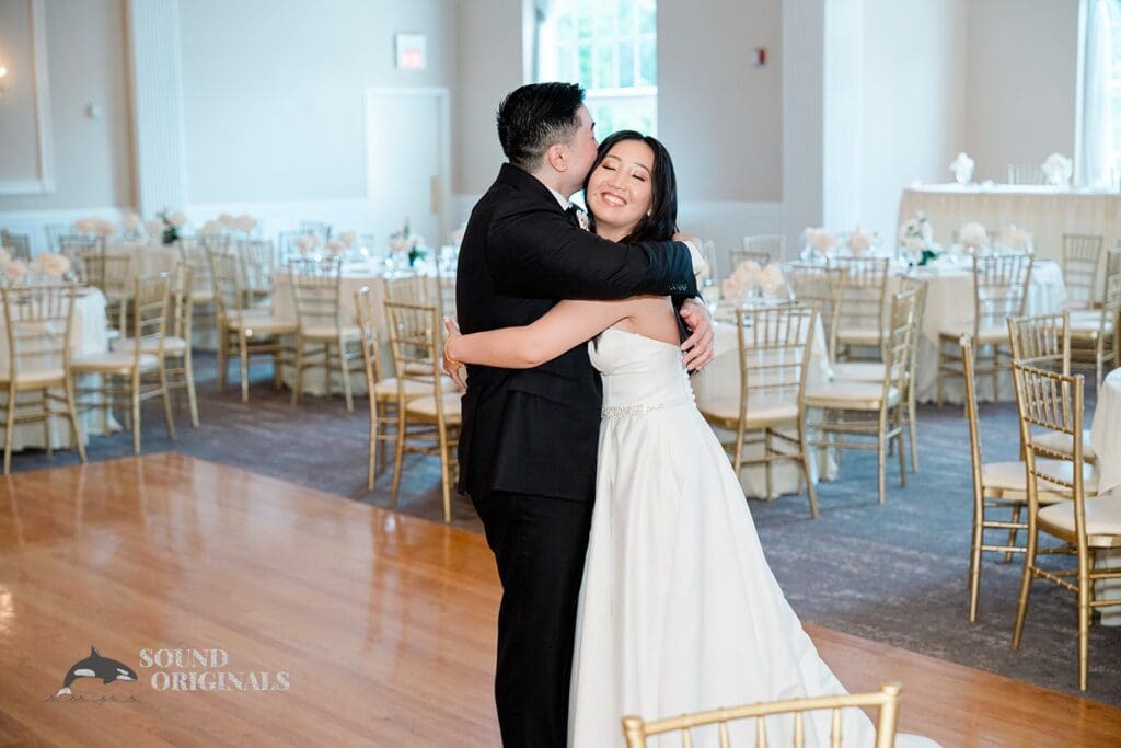 A hug between the bride and groom at The Abbington Distinctive Banquets Wedding reception