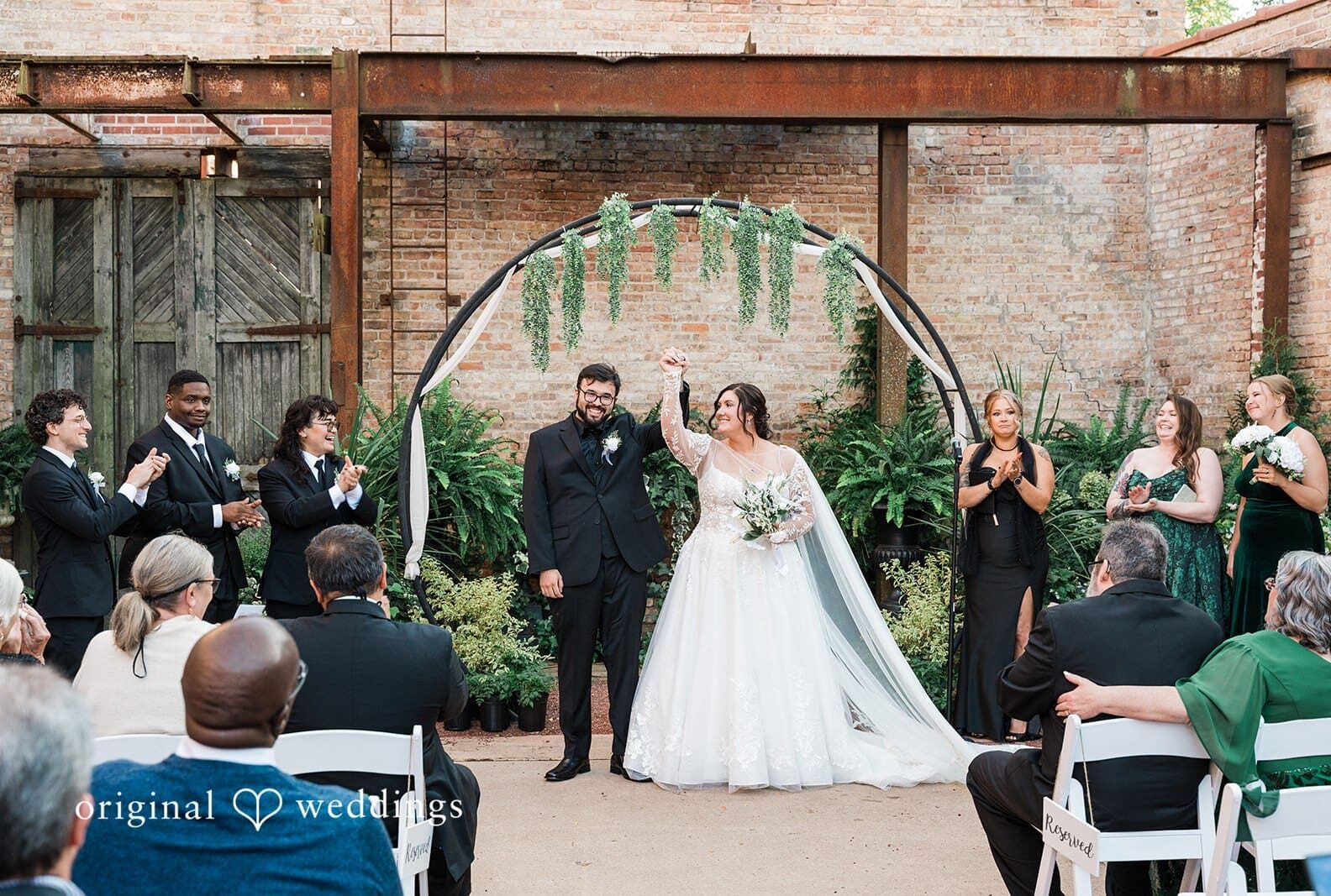 Chicago wedding photographers capturing couple raising hands and smiling at Blumen Gardens by Original Weddings