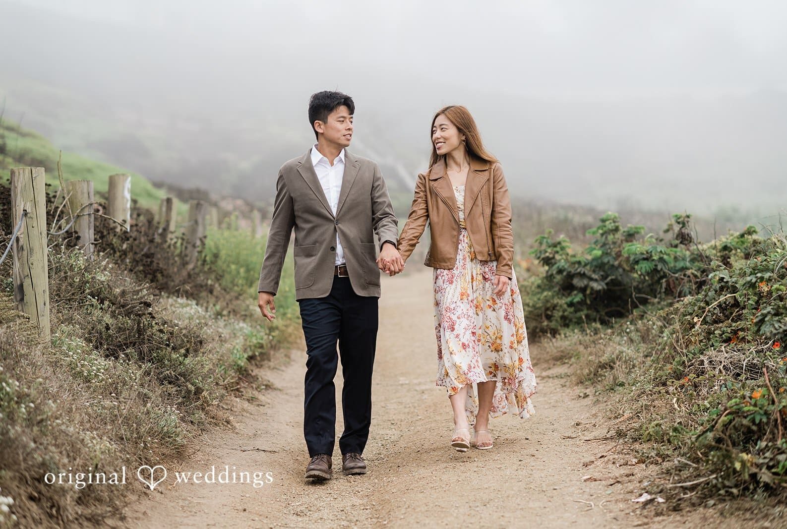 Engagement photography services by Original Weddings capturing close-up of couple with bride smiling at Sutro Baths.